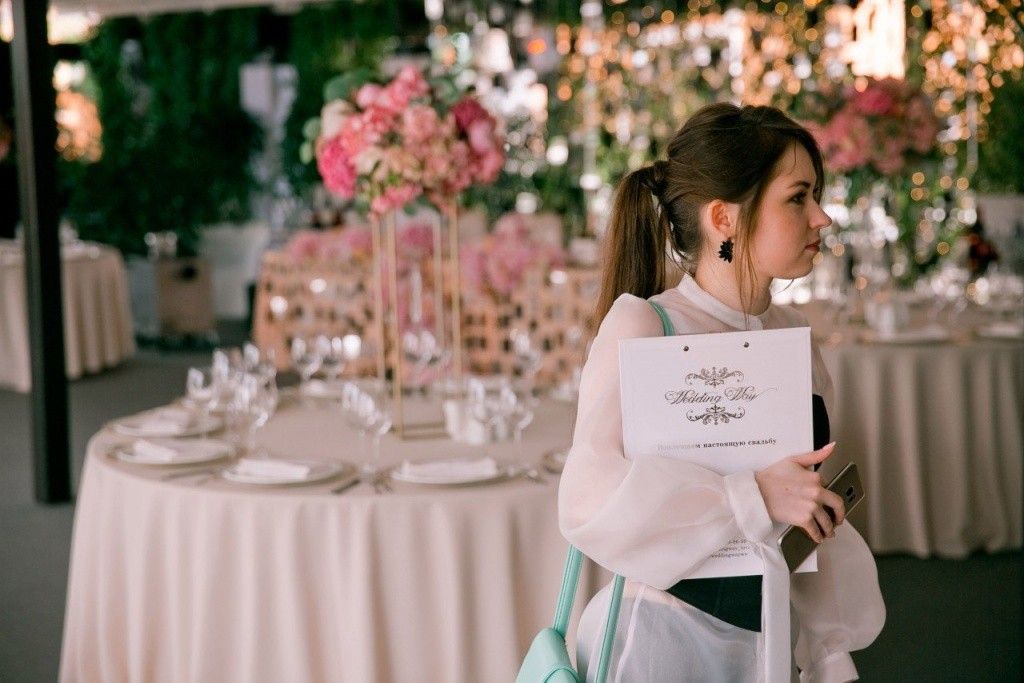 Two planners shaking hands over a blueprint